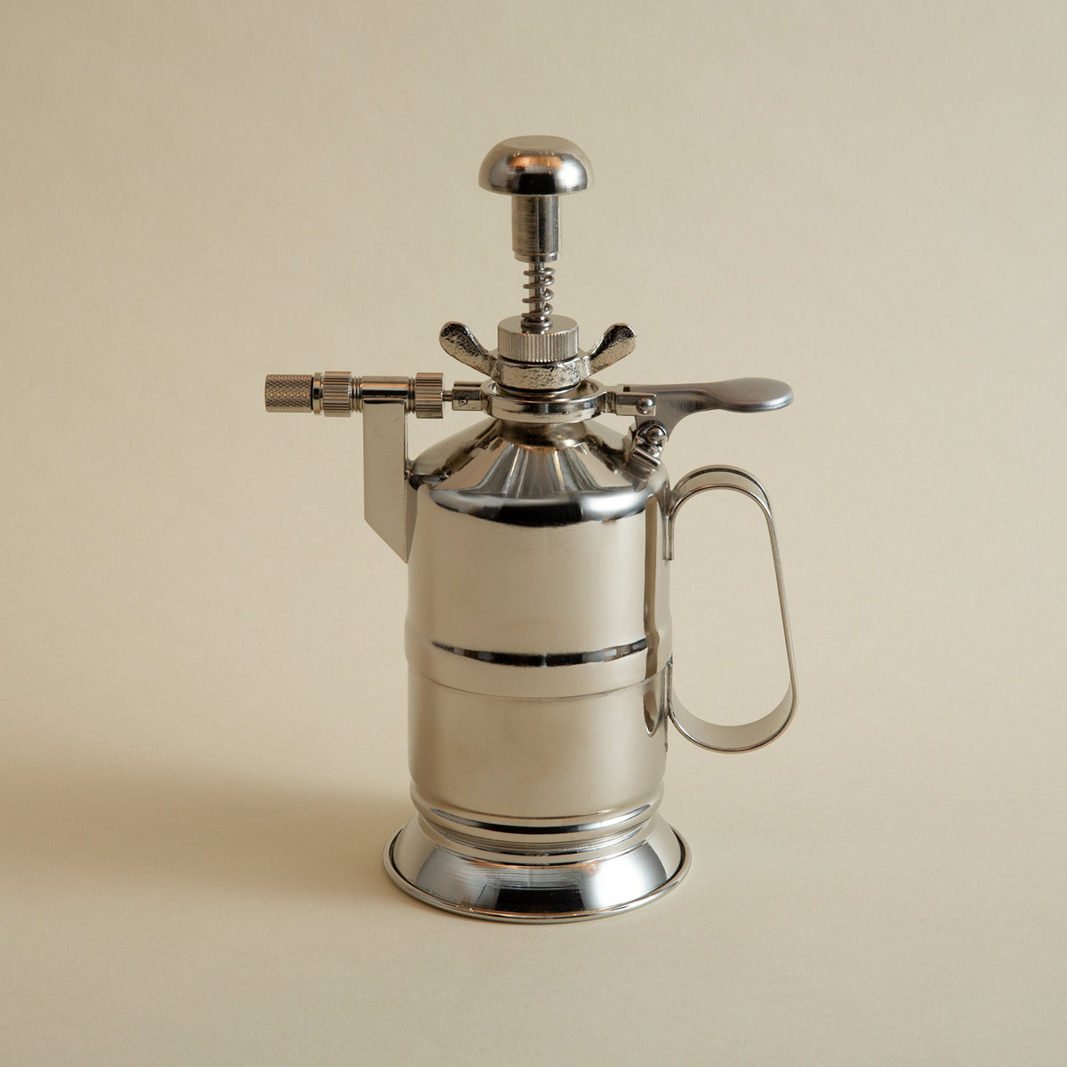 Silver vintage-style spray can on a beige background