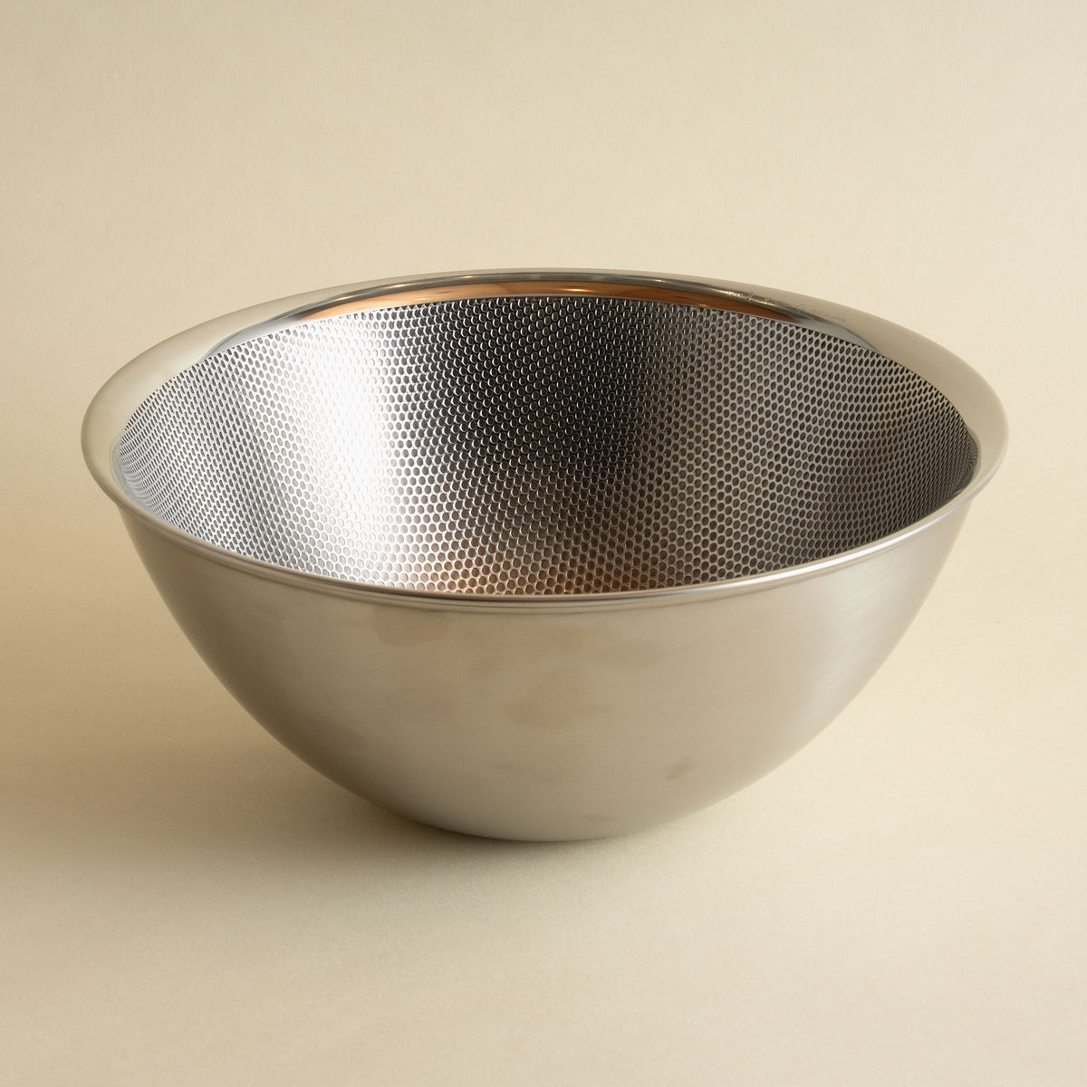 Sori Yanagi Japanese stainless steel mixing bowl nested on Sori Yanagi Colander