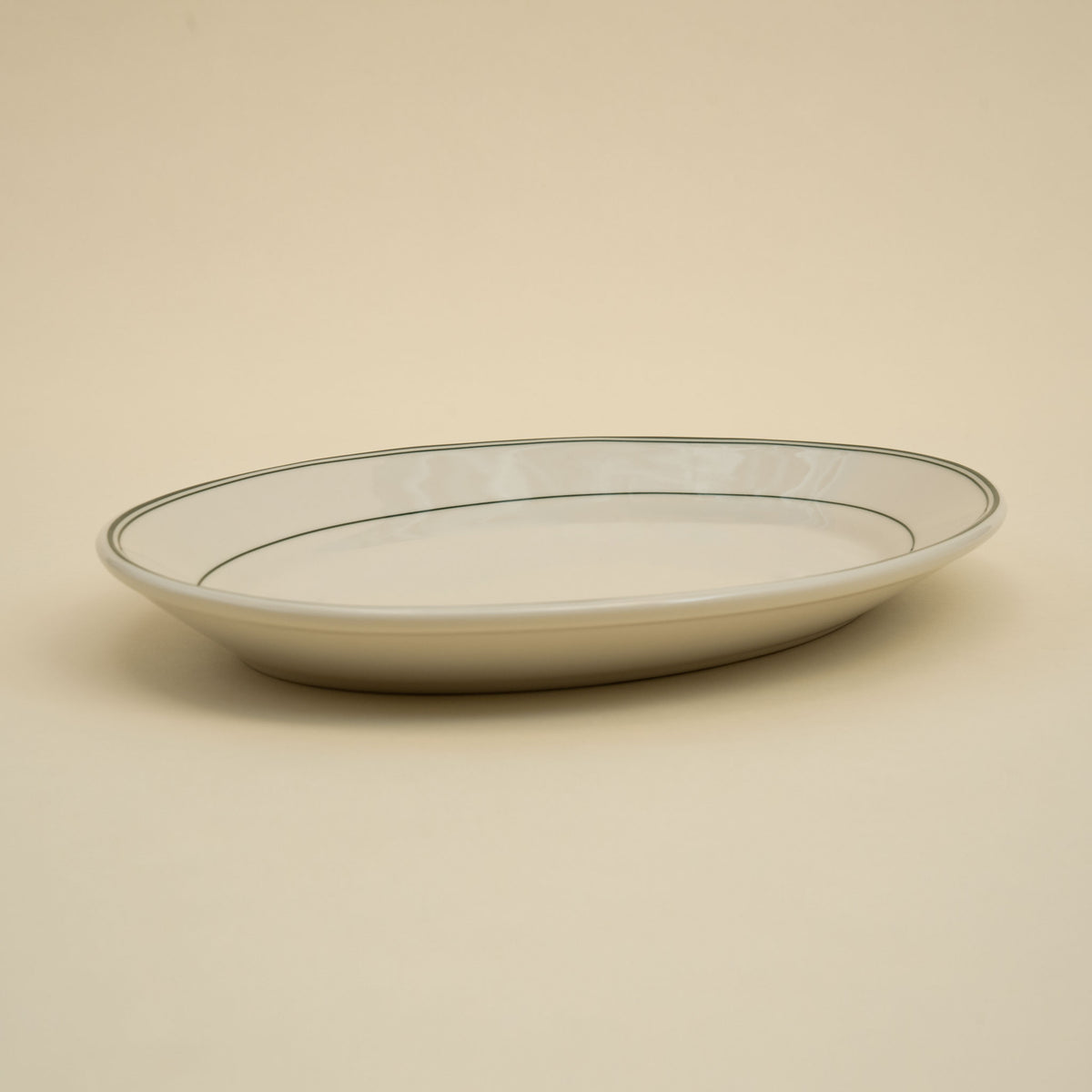 An oval green-banded american diner ceramic serving platter.
