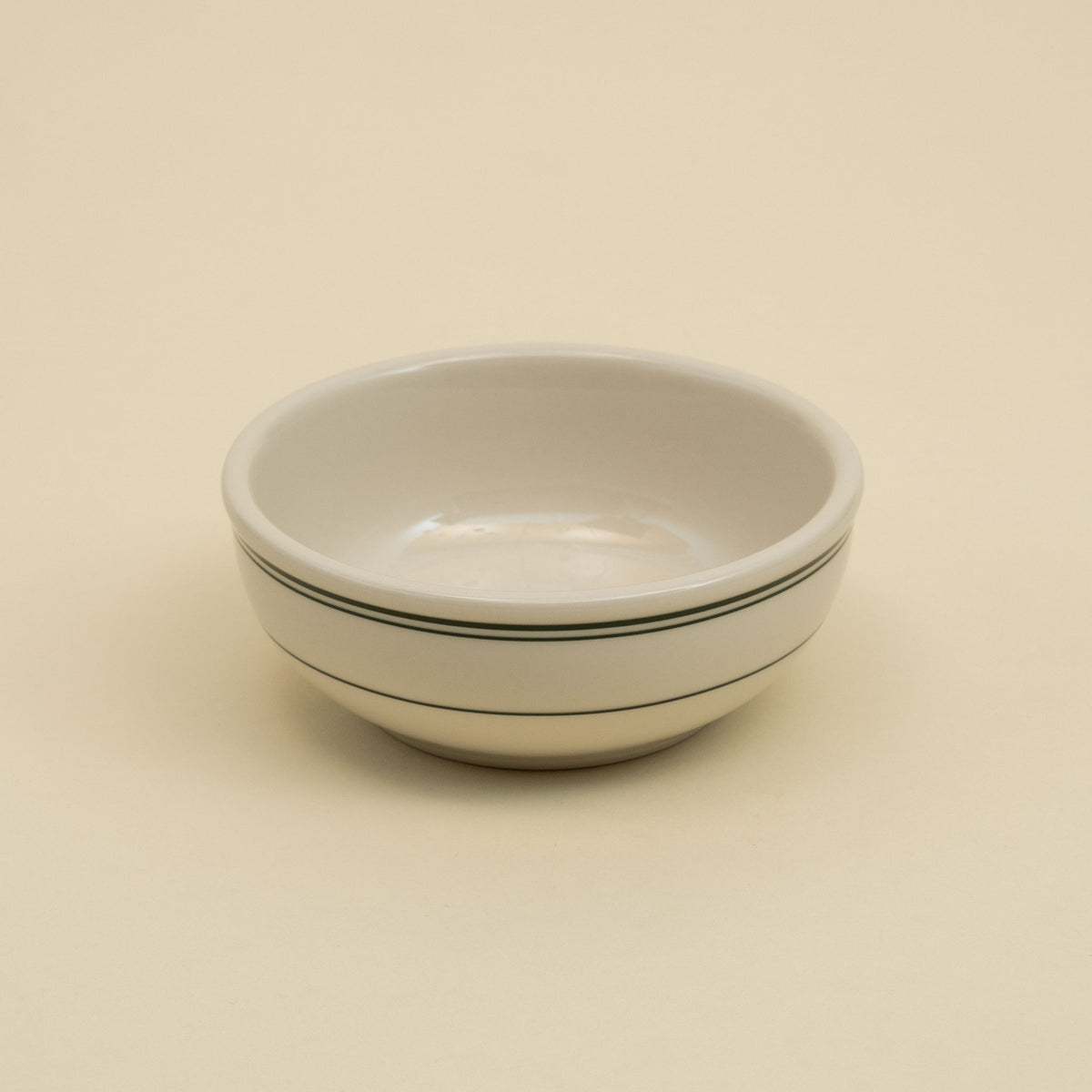 Green-banded American diner-style yogurt bowl in white ceramic