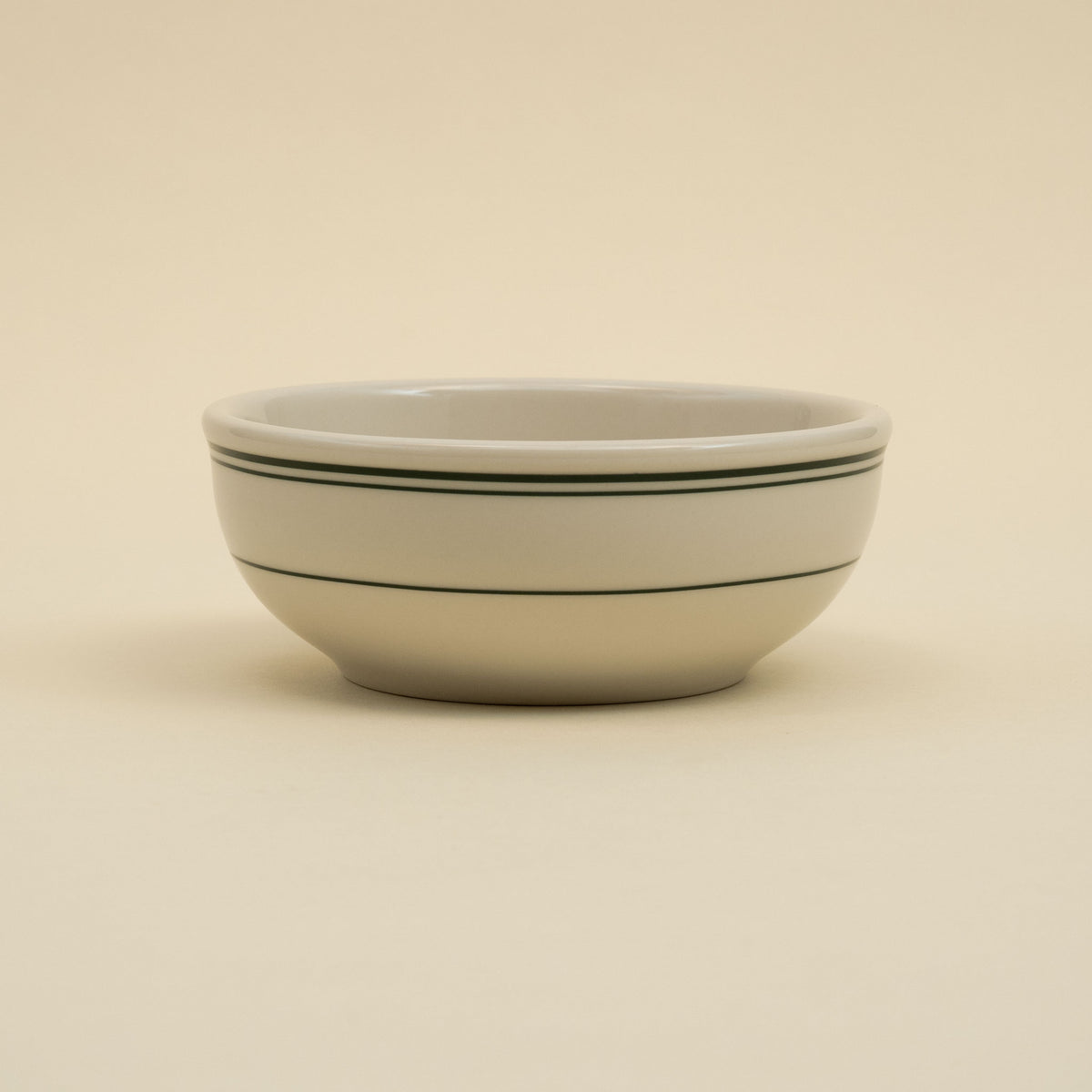 Green-banded American diner-style yogurt bowl in white ceramic