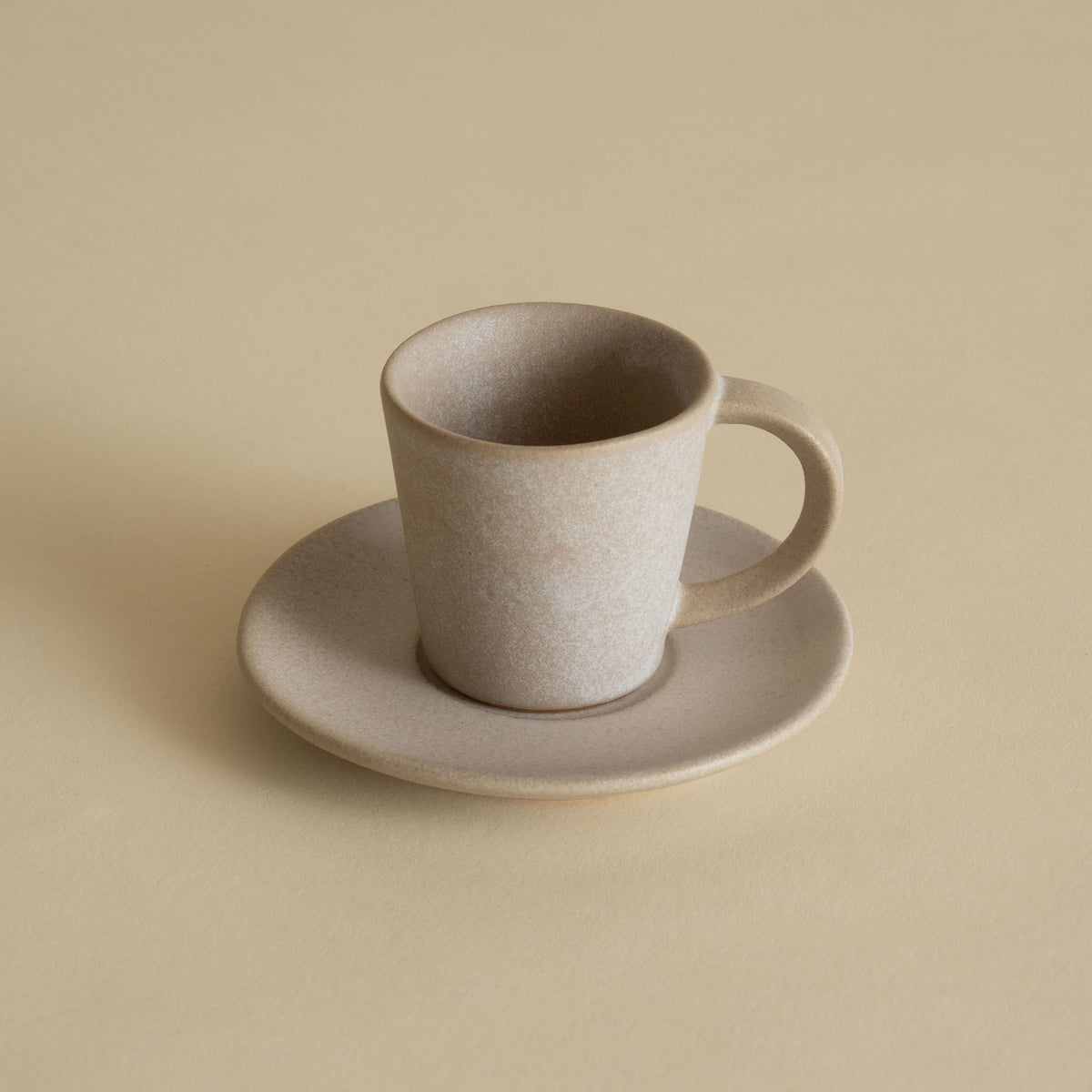 Handmade ceramic espresso cup and saucer in stone beige