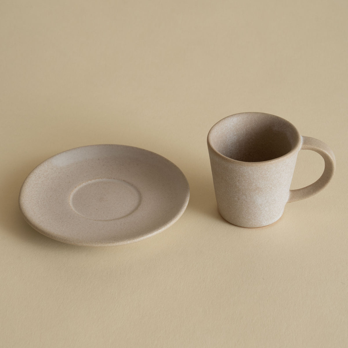 Handmade ceramic espresso cup and saucer in stone beige